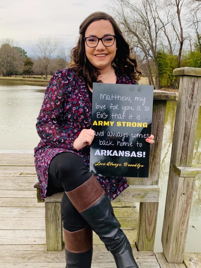 brook morgan holding arkansas sign